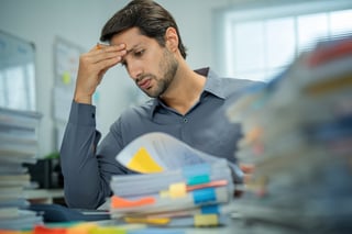 Overworked businessman frustrated with work pressure, stressed and burnout